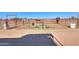 View of a horse corral with metal fencing, dirt ground, and multiple horses at 10137 N White Rd, Maricopa, AZ 85139