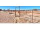 Another angle of a rustic horse corral with metal fencing and open space for horses at 10137 N White Rd, Maricopa, AZ 85139