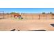 Multiple horse stables with metal fencing and horses visible at 10137 N White Rd, Maricopa, AZ 85139