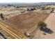 Aerial view of a large horse stable with horses and riding arena at 10137 N White Rd, Maricopa, AZ 85139