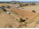 Aerial view of a large horse stable with horses and riding arena at 10137 N White Rd, Maricopa, AZ 85139