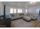 Bright living room with comfy sofas, a rug, and large windows at 10137 N White Rd, Maricopa, AZ 85139