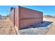 Side view of a large metal storage container on a paved area at 10137 N White Rd, Maricopa, AZ 85139