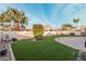 Backyard with artificial turf and decorative fountain at 10606 E Hercules Dr, Sun Lakes, AZ 85248