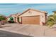 Tan house with brown garage door and desert landscaping at 10606 E Hercules Dr, Sun Lakes, AZ 85248