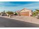 Tan house with brown garage door and desert landscaping at 10606 E Hercules Dr, Sun Lakes, AZ 85248