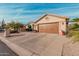 Tan house with brown garage door and desert landscaping at 10606 E Hercules Dr, Sun Lakes, AZ 85248