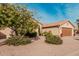 Tan house with brown garage door and desert landscaping at 10606 E Hercules Dr, Sun Lakes, AZ 85248