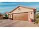 Tan house with brown garage door and desert landscaping at 10606 E Hercules Dr, Sun Lakes, AZ 85248