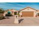 Tan house with brown garage door, green awning, and desert landscaping at 10606 E Hercules Dr, Sun Lakes, AZ 85248