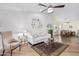 Light and airy living room with hardwood floors, light-colored furniture, and a ceiling fan at 10606 E Hercules Dr, Sun Lakes, AZ 85248