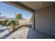 Covered patio, grassy area, and mature plants at 10950 N 184Th Dr, Surprise, AZ 85388