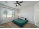 Spacious bedroom with a green duvet and large window at 10950 N 184Th Dr, Surprise, AZ 85388