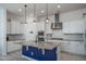 Modern kitchen with white cabinets, granite countertops, and a blue island at 10950 N 184Th Dr, Surprise, AZ 85388