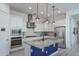 Modern kitchen with white cabinets, granite countertops, and a large island at 10950 N 184Th Dr, Surprise, AZ 85388