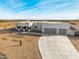 Aerial view of a single-story house with a three-car garage and desert landscaping at 12093 W Blackhawk Rd, Casa Grande, AZ 85194