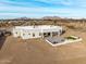 Aerial view of a house with a large backyard patio and artificial turf at 12093 W Blackhawk Rd, Casa Grande, AZ 85194