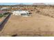 Aerial view of a house with a large backyard and surrounding desert landscape at 12093 W Blackhawk Rd, Casa Grande, AZ 85194