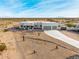 Aerial view of a single-story house with a three-car garage and desert landscaping at 12093 W Blackhawk Rd, Casa Grande, AZ 85194