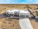 Aerial view of a single-story house with a three-car garage and desert landscaping at 12093 W Blackhawk Rd, Casa Grande, AZ 85194