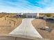 Aerial view of a single-story house with a three-car garage and desert landscaping at 12093 W Blackhawk Rd, Casa Grande, AZ 85194