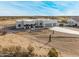 Aerial view of a single-story house with a three-car garage and desert landscaping at 12093 W Blackhawk Rd, Casa Grande, AZ 85194