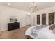 Main bedroom with wood floors and ensuite bathroom at 12093 W Blackhawk Rd, Casa Grande, AZ 85194