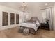 Main bedroom with wood floors, chandelier, and wall art at 12093 W Blackhawk Rd, Casa Grande, AZ 85194