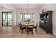 Bright dining area with large window and view, hardwood floors, and stylish furniture at 12093 W Blackhawk Rd, Casa Grande, AZ 85194