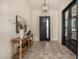 Bright entryway with tile flooring, console table, and modern light fixture at 12093 W Blackhawk Rd, Casa Grande, AZ 85194