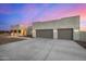 Contemporary desert home with a large driveway and three-car garage at 12093 W Blackhawk Rd, Casa Grande, AZ 85194