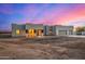 Modern stucco home with three-car garage at sunset at 12093 W Blackhawk Rd, Casa Grande, AZ 85194