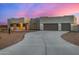 Contemporary home exterior with long driveway and desert landscaping at 12093 W Blackhawk Rd, Casa Grande, AZ 85194