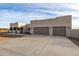 Contemporary desert home with a large driveway and three-car garage at 12093 W Blackhawk Rd, Casa Grande, AZ 85194