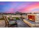 Backyard fire pit with seating and sunset view at 12093 W Blackhawk Rd, Casa Grande, AZ 85194