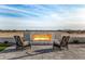 Outdoor firepit with seating area and desert views at 12093 W Blackhawk Rd, Casa Grande, AZ 85194