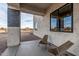 Modern covered porch with two wooden chairs and desert views at 12093 W Blackhawk Rd, Casa Grande, AZ 85194