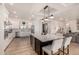 Modern kitchen with white cabinets, large island, and stainless steel appliances at 12093 W Blackhawk Rd, Casa Grande, AZ 85194