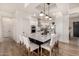 Modern kitchen with white cabinets, island with seating, and stainless steel appliances at 12093 W Blackhawk Rd, Casa Grande, AZ 85194