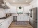 Modern kitchen with white cabinets, stainless steel appliances, and a large island at 12093 W Blackhawk Rd, Casa Grande, AZ 85194