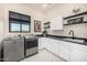 Bright laundry room with cabinets and countertop space at 12093 W Blackhawk Rd, Casa Grande, AZ 85194