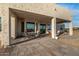 Covered patio with dining table and seating area at 12093 W Blackhawk Rd, Casa Grande, AZ 85194