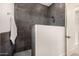 Spacious shower with dark gray tile and built-in bench at 12093 W Blackhawk Rd, Casa Grande, AZ 85194