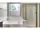 Bathroom with a shower and bathtub, ideal for relaxation at 13434 W Jacobson Dr, Litchfield Park, AZ 85340