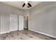 Bedroom with double door closet and wood-look floors at 13434 W Jacobson Dr, Litchfield Park, AZ 85340