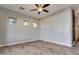 Bright bedroom featuring wood-look floors and ceiling fan at 13434 W Jacobson Dr, Litchfield Park, AZ 85340