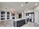 Kitchen features island, dark cabinets, and stainless steel appliances at 13434 W Jacobson Dr, Litchfield Park, AZ 85340