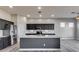 Modern kitchen with dark cabinets and quartz countertops at 13434 W Jacobson Dr, Litchfield Park, AZ 85340