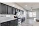 Modern kitchen with dark cabinetry and stainless steel appliances at 13434 W Jacobson Dr, Litchfield Park, AZ 85340