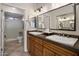 Double vanity bathroom with granite countertops and large mirror at 1351 N Pleasant Dr # 1118, Chandler, AZ 85225